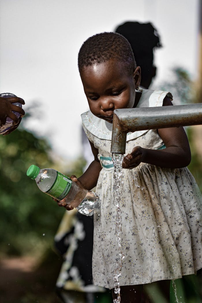 young girl collecting water in kampala uganda 35094211